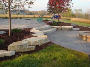 Landscapers add hardscape to a Schererville home