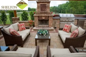 Schererville Landscape Contractors outdoor living with wicker furniture, fireplace, and kitchen